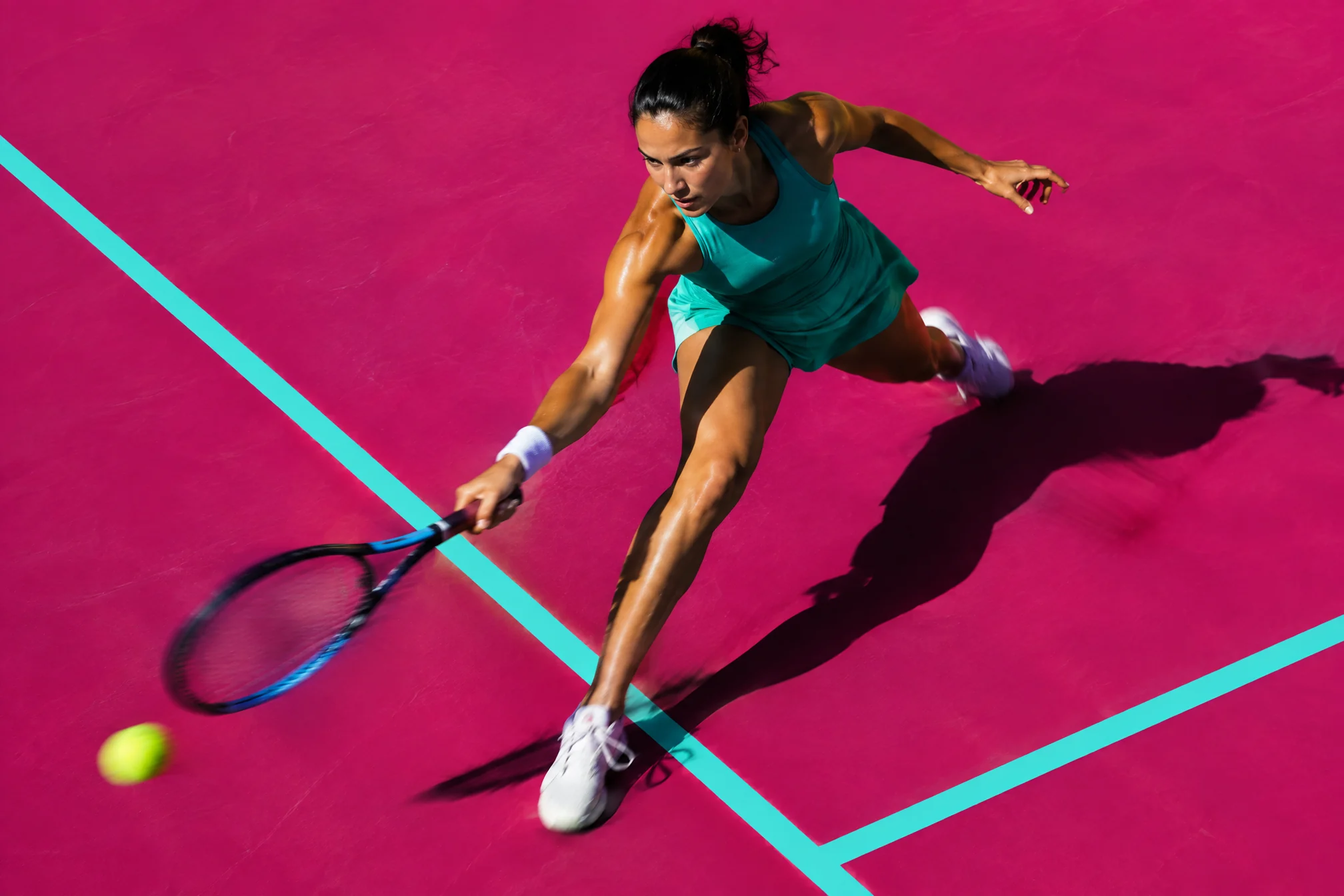 Tennis player lunging for a forehand on a hot magenta court